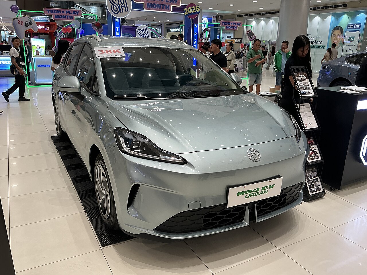 MG4 Urban electric hatch in pale green at a shopping centre display, front three-quarter view