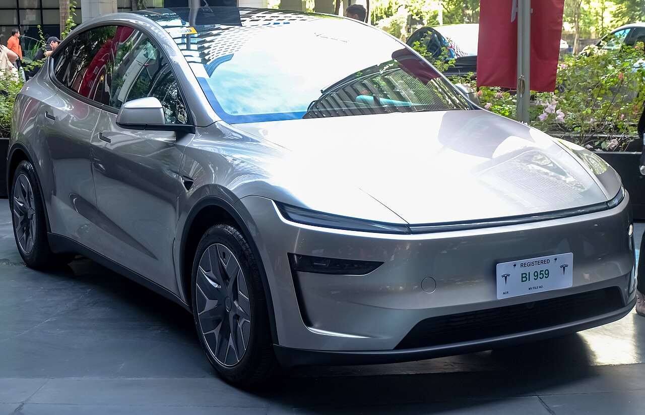 Tesla Model Y L in Cosmic Silver, front three-quarter view